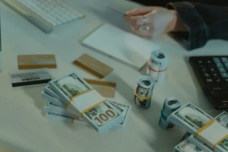 Close-up of dollar bills and credit cards on a desk, symbolizing financial transactions.